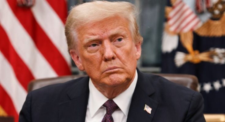 Trump signing executive order at desk