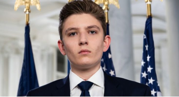 Barron Trump standing beside family