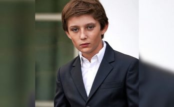 Barron Trump standing quietly