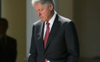 Bill Clinton reviewing news articles