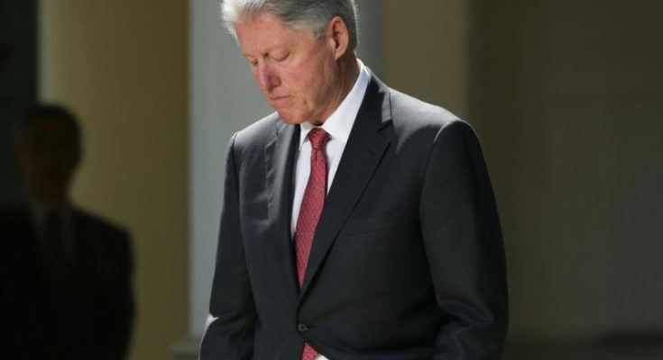 Bill Clinton reviewing news articles
