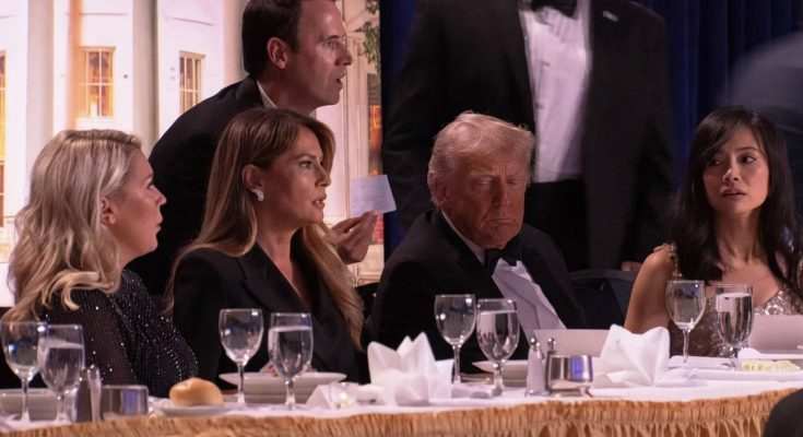formal dinner setting with five people in discussion, focus on table