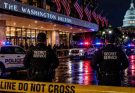secret Service agents outside Washington Hilton at night with police cars