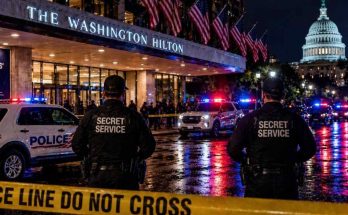 secret Service agents outside Washington Hilton at night with police cars