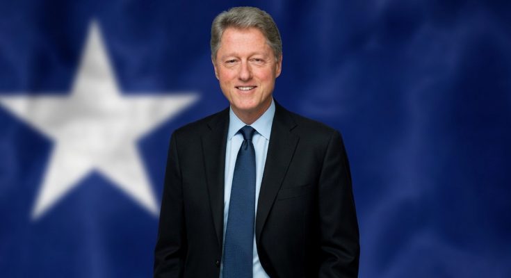 man in suit with star backdrop, smiling confidently