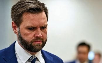 serious man in blue suit focused in office setting