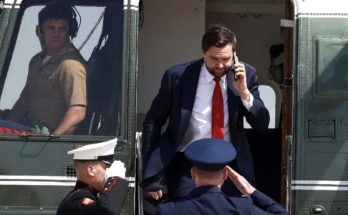 JD Vance exits Marine One helicopter while on phone call as uniformed Marines salute
