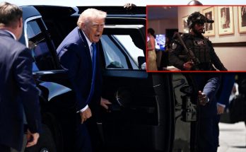 man in suit entering black vehicle amid security personnel