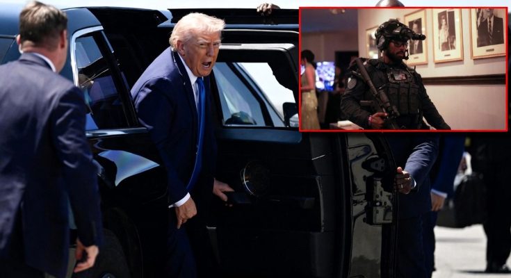 man in suit entering black vehicle amid security personnel