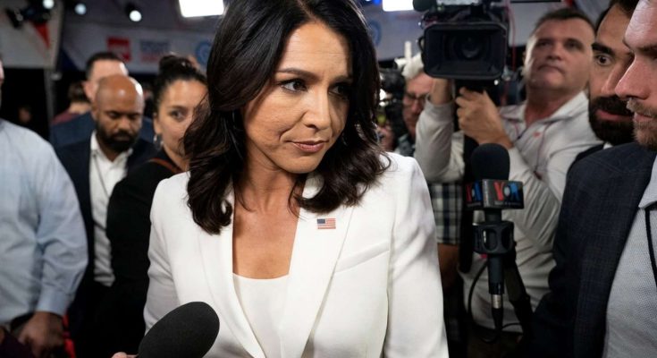 confident woman in white suit surrounded by press at event