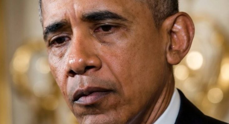 former President Barack Obama speaking at podium with solemn expression during formal