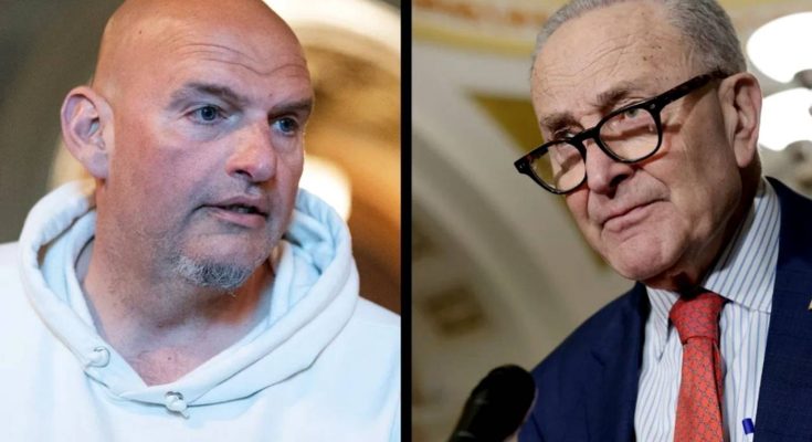 senator John Fetterman in white hoodie beside Senator Chuck Schumer at Capitol press