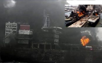 burning ship with thick smoke engulfing the port area