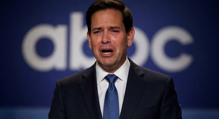emotional man in suit against ABC backdrop, tears visible