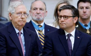 speaker Mike Johnson and Mitch McConnell seated together during formal event with Medal