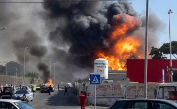 massive industrial fire erupts near Rome with thick black smoke billowing over highway