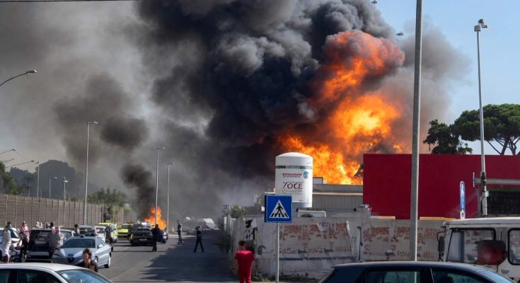 massive industrial fire erupts near Rome with thick black smoke billowing over highway