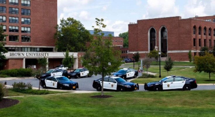 police cars parked at Brown University campus entrance, sunny day