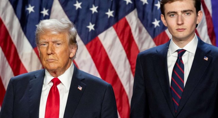 two men in suits with American flags in background