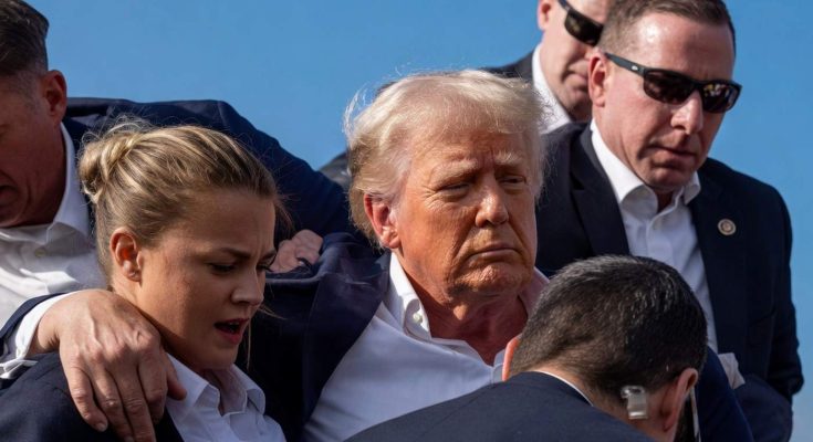 donald Trump surrounded by Secret Service agents with female agent in foreground during