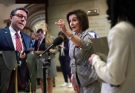 nancy Pelosi gestures emphatically during Capitol hallway interview with bold text