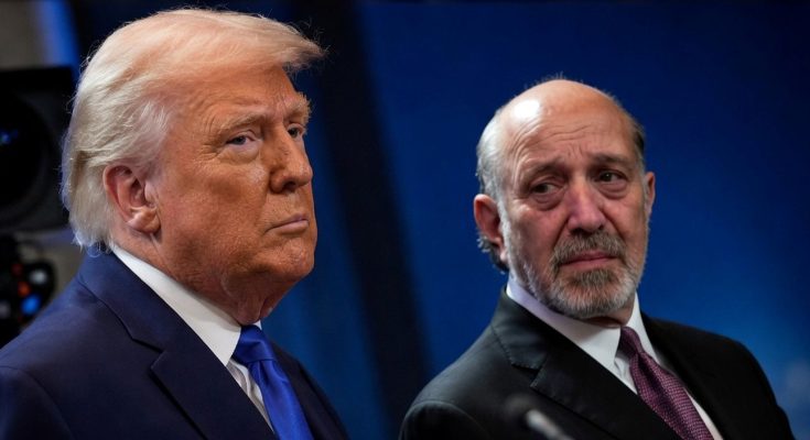 two prominent men in suits at a public event