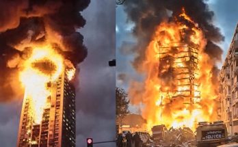 high-rise building engulfed in flames with thick smoke, dramatic scene