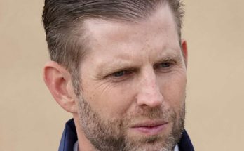 eric Trump wearing navy blue jacket with serious expression, headline about family member