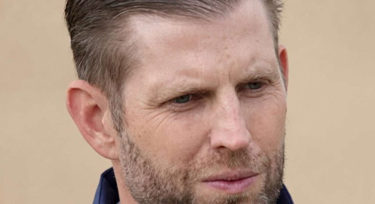 eric Trump wearing navy blue jacket with serious expression, headline about family member