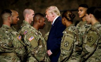 president meeting soldiers in military uniforms indoors