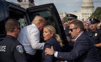 security escorting a man into a vehicle near the Capitol