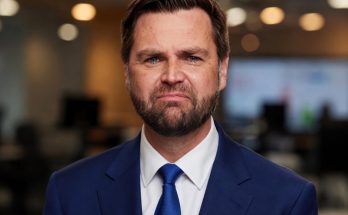 man in blue suit with tears in office setting, sad news