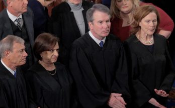 judges in formal robes standing in courtroom during a session