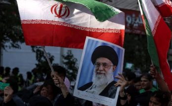 protesters wave Iranian flag and leader's portrait at rally