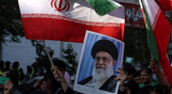 protesters wave Iranian flag and leader's portrait at rally