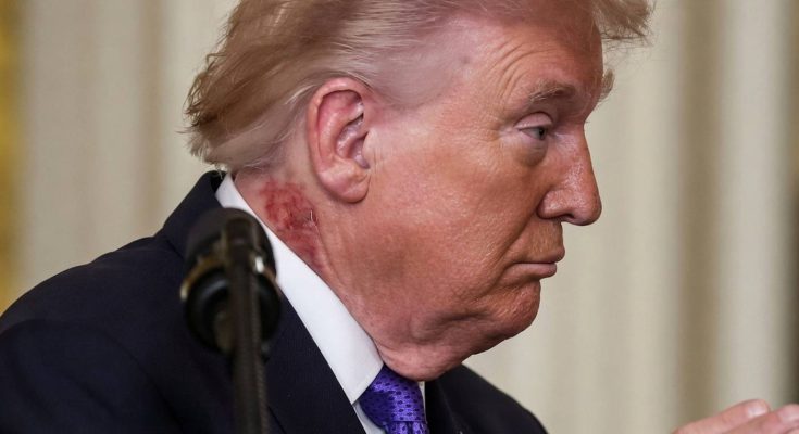 profile of a man in a suit with microphone in focus