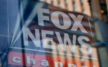 fox News logo with American flag reflection on glass