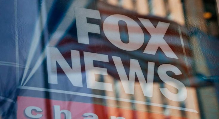 fox News logo with American flag reflection on glass