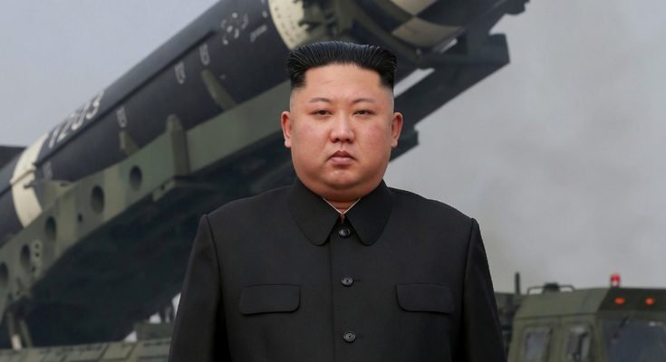 kim Jong Un stands before Hwasong-15 intercontinental ballistic missile on mobile launcher