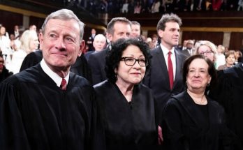 judges gathered at a formal event, wearing black robes
