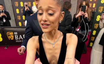 ariana Grande signing autographs at BAFTA red carpet wearing black velvet bodice and pink