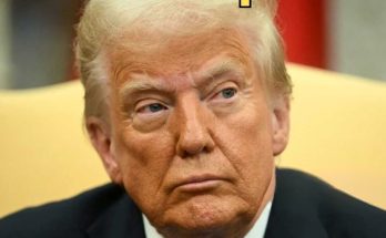 close-up of a serious man in a formal setting during a discussion