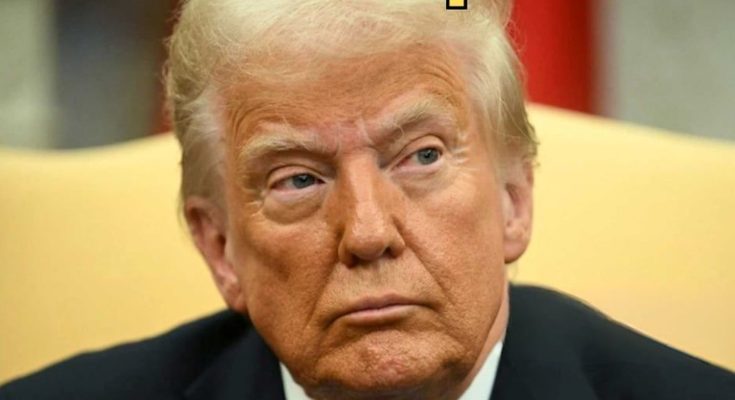 close-up of a serious man in a formal setting during a discussion