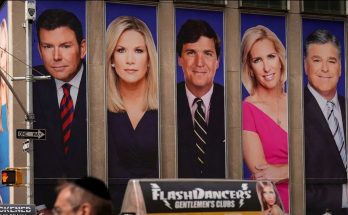 news anchors' portraits on building facade, New York City street