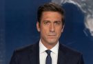 news anchor David Muir stands at desk in ABC World News Tonight studio with digital globe