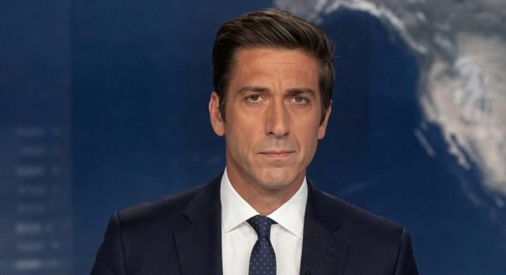 news anchor David Muir stands at desk in ABC World News Tonight studio with digital globe