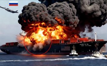 massive fire engulfing cargo ship with Russian flag and jets overhead