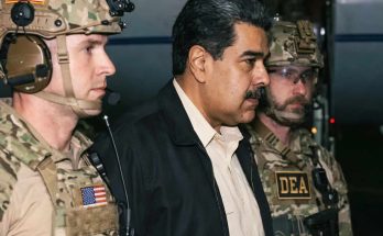 DEA agents escorting man in dark jacket, serious expressions