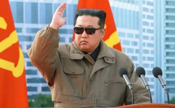 leader saluting with red flags in urban setting