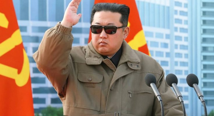 leader saluting with red flags in urban setting